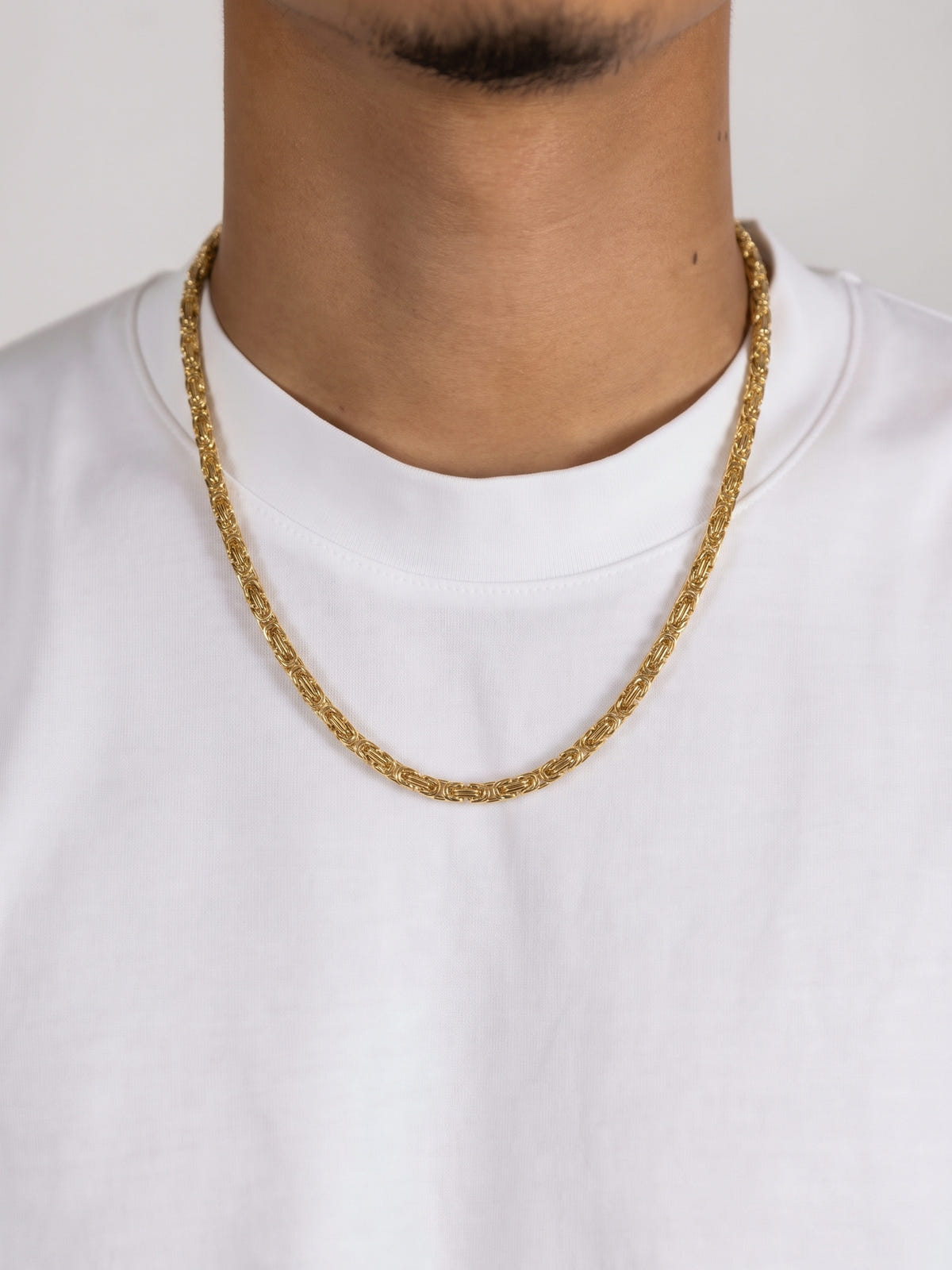 King's Chain Gold Stainless Steel (4mm) worn by a model in a white T-shirt, front view