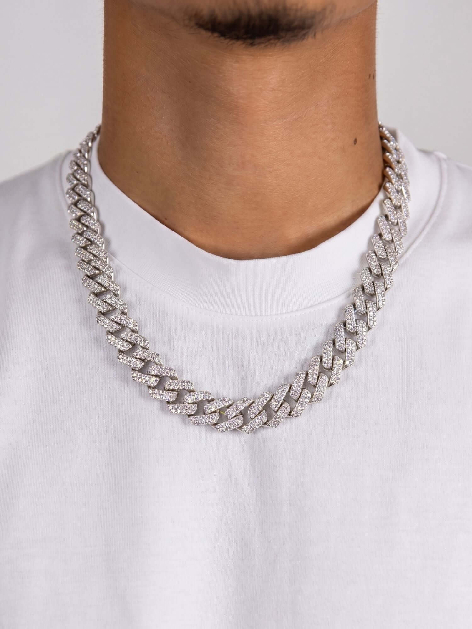 Moissanite Cuban link necklace 925 silver ICED OUT (12mm) on a model in a white T-shirt.