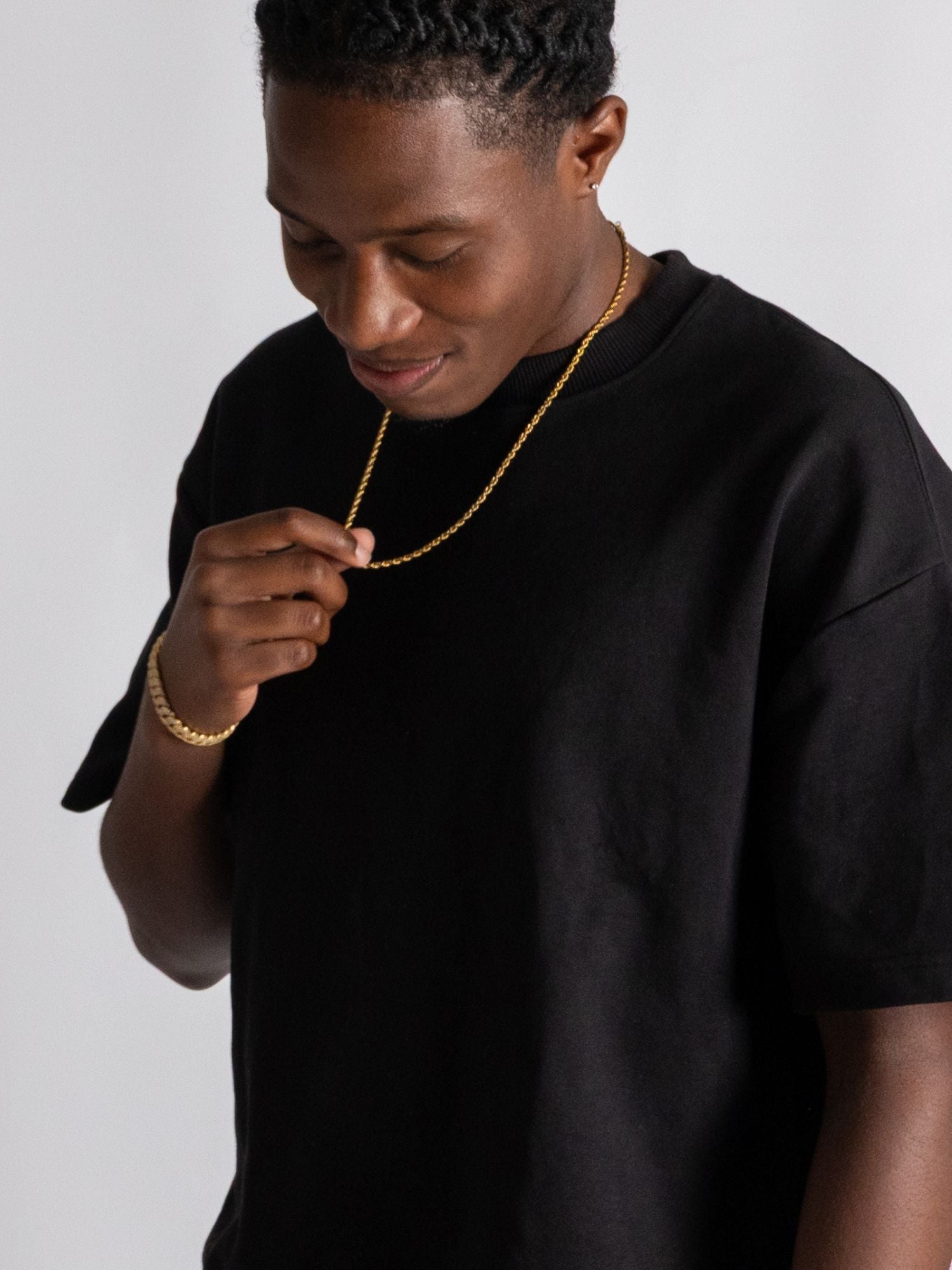 Modèle portant een gouden rope ketting 2MM en 3MM van Carpe Ice met een zwarte T-shirt.
