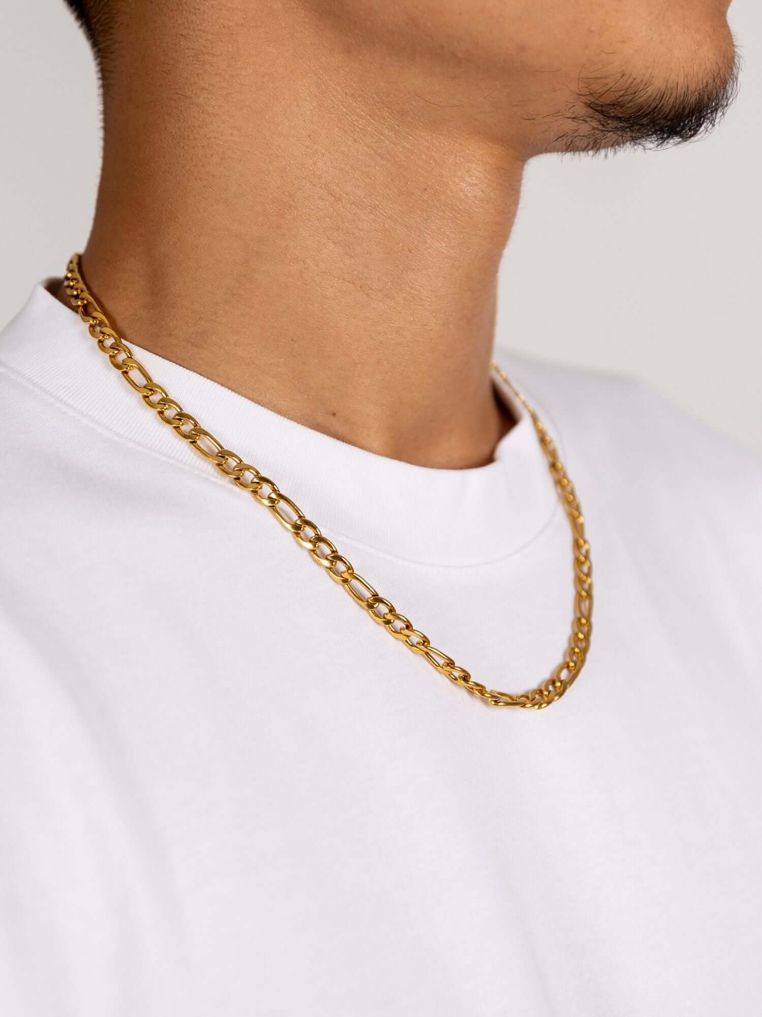 Figaro Chain Necklace in Gold Stainless Steel (3mm & 6mm) worn around the neck, gold-tone Figaro link chain in stainless steel