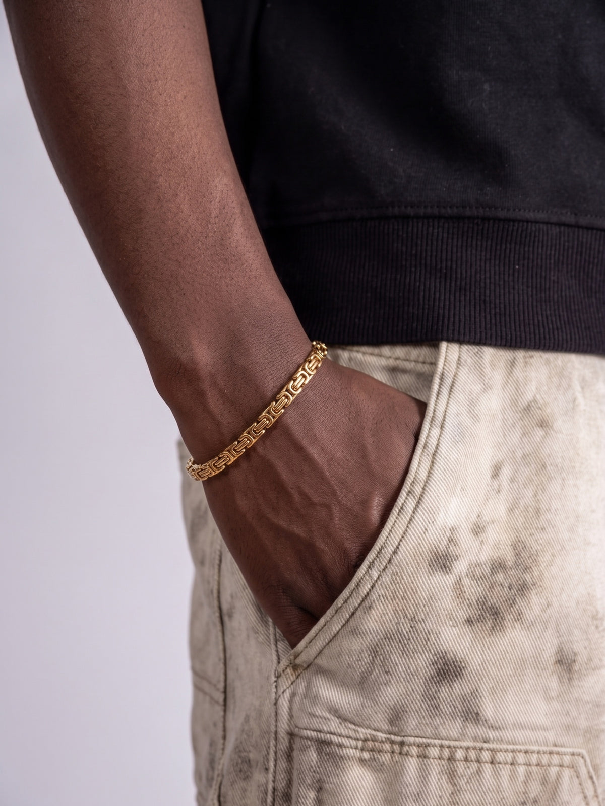 King's Link Bracelet Gold Stainless Steel 4mm, on the wrist, slim gold-tone king's link worn with a black shirt