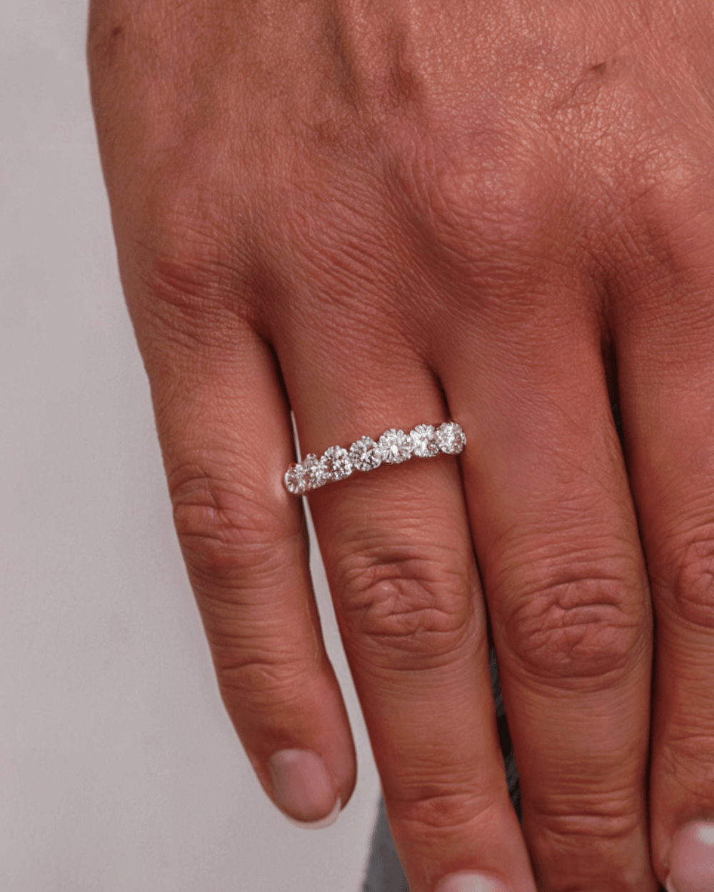 Moissanite tennis ring in 925 sterling silver with sparkling diamonds, worn by a woman up close