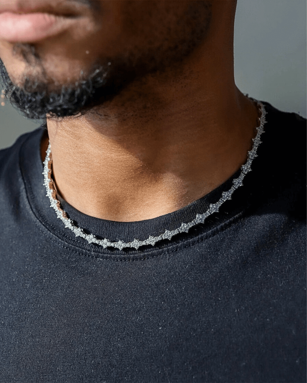 Man wearing a sparkling ICED OUT Honeycomb necklace, showcasing its elegant design and luxurious shine.