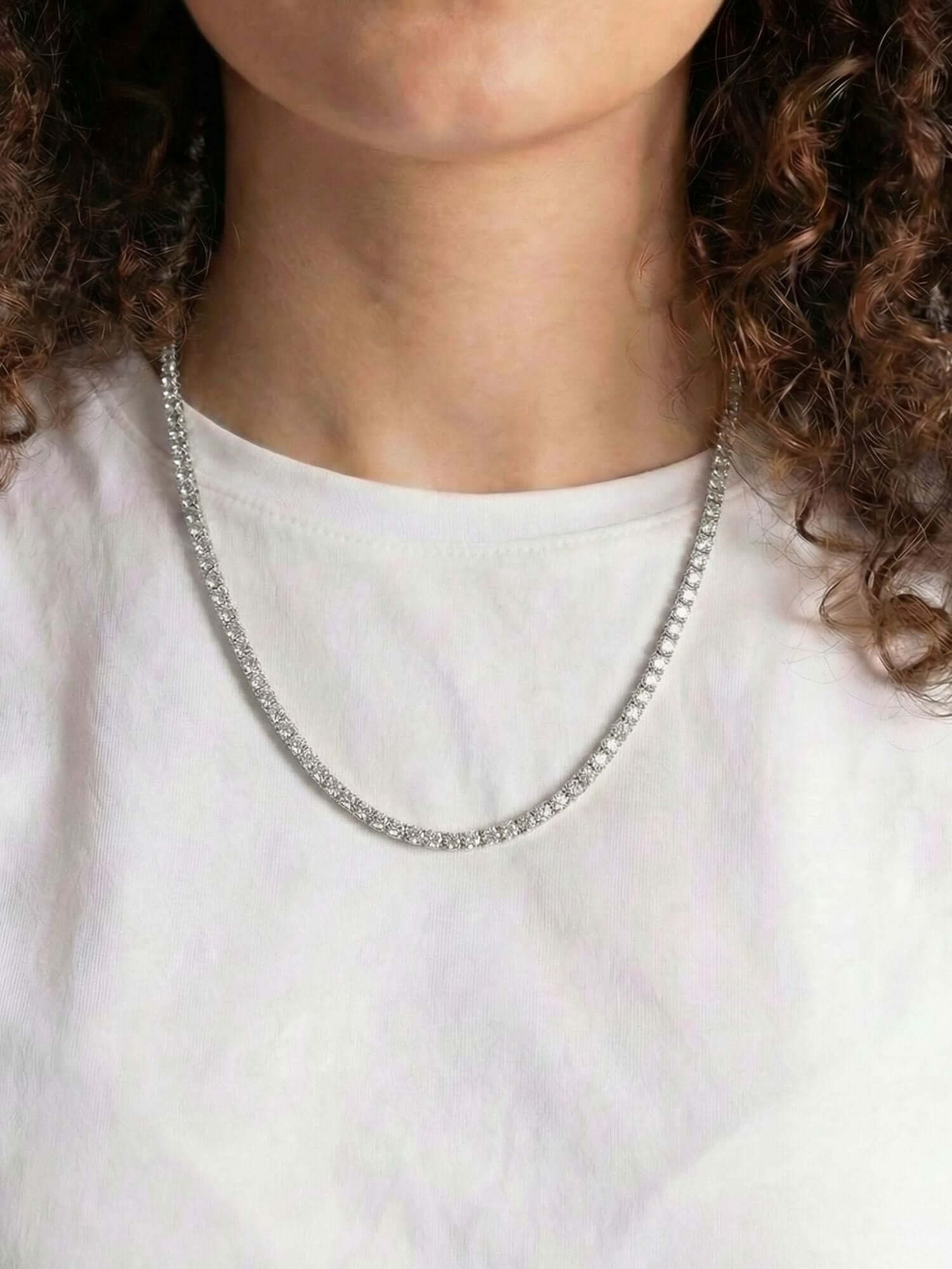 Silver Tennis Chain (3mm & 5mm) silver tennis chain with VVS CZ stones worn around the neck, luxury box clasp closure